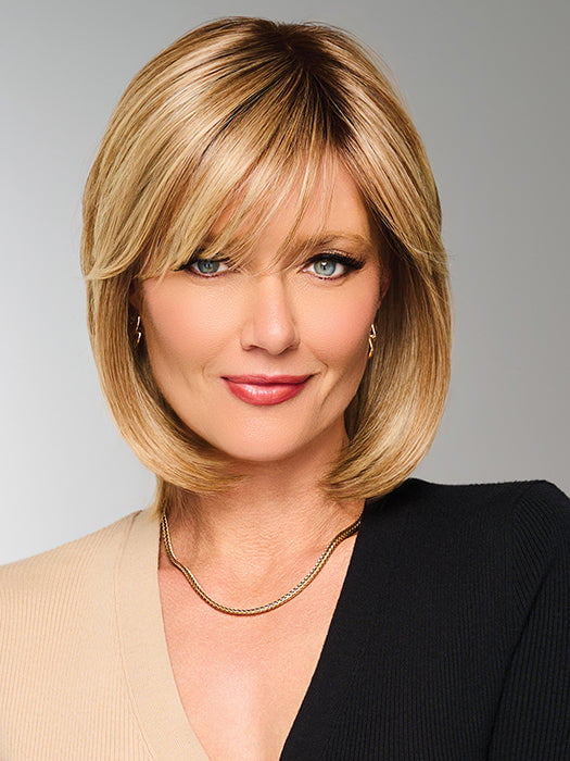 Model is wearing TIMELESS CHARM by RAQUEL WELCH in color  RL14/22SS SHADED WHEAT | Dark Blonde Evenly Blended with Platinum Blonde with Dark Roots