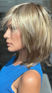 Model is wearing RAINBOW by ELLEN WILLE in color SAND MULTI ROOTED 14.24.12 | Medium Ash Blonde, Lightest Ash Blonde, and Lightest Brown Blend with Dark Shaded Roots