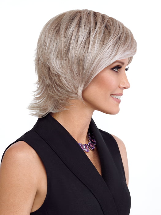 Model is wearing RAZOR CUT SHAG by TRESSALLURE in color 56/60/R8 | Lightest Grey Blend Rooted Medium Brown