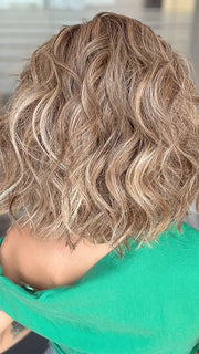 Model is wearing ROMANTIC RENAISSANCE by RAQUEL WELCH in color SS12/22 SHADED CAPPUCCINO | Light Golden Brown Evenly Blended with Cool Platinum Blonde Highlights and Dark Roots