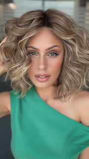 Model is wearing ROMANTIC RENAISSANCE by RAQUEL WELCH in color SS12/22 SHADED CAPPUCCINO | Light Golden Brown Evenly Blended with Cool Platinum Blonde Highlights and Dark Roots
