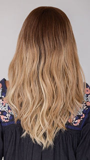 Roxie wearing BALAYAGE BEAUTY by RAQUEL WELCH in RL8/24OM | Medium brown blended roots that transition into a golden blonde ombré from midlength to the ends