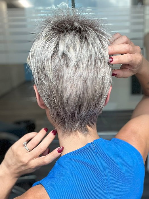 Model is wearing CHAT by ELLEN WILLE in color PEARL ROOTED | Pearl Platinum with Medium Ash Blonde and Lightest Brown with Grey Blend and Shaded Roots