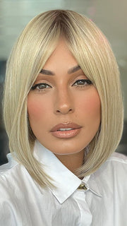 Model is wearing PAIGE by ENVY in color SILKY BEIGE | Light Platinum Blonde with Dark Brown Roots