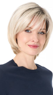 Model is wearing SHEILA by ENVY in color PLATINUM SHADOW | Light Blonde with Dark Roots