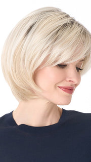 Model is wearing SHEILA by ENVY in color PLATINUM SHADOW | Light Blonde with Dark Roots
