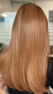 Model is wearing SLEEK SOPHISTICATION by RAQUEL WELCH in color RL29/33SS ICED PUMPKIN SPICE | Strawberry Blonde shaded with Dark Red-Brown