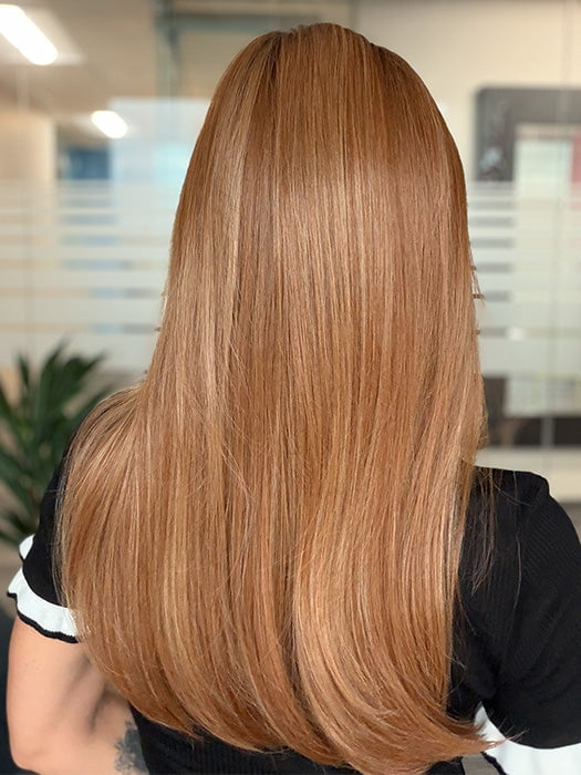 Model is wearing SLEEK SOPHISTICATION by RAQUEL WELCH in color RL29/33SS ICED PUMPKIN SPICE | Strawberry Blonde shaded with Dark Red-Brown