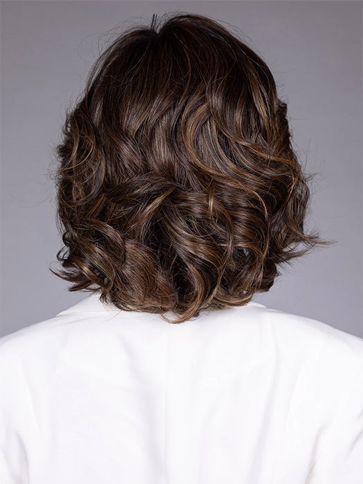 Model is wearing TWAIN in color FRENCH ROAST BROWN R | A deep, luxurious brunette featuring a dark brown base with warm bronze and subtle red undertones. Softly rooted for natural depth and dimension.