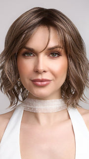 Terra by Amore in color BRONDE-R | Dark brown and natural medium blond tones are mixed together and shaded with medium dark brown roots for a realistic appearance.
