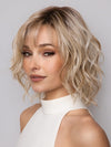 Model is wearing Terra by Amore in color SEA SALT BLOND R | A perfect mixture of cool, icy-blond and warm-dark blond. The rich brown root tone enhances the modern appearance