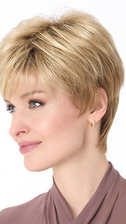 Model is wearing TIFFANY by ENVY in color SPARKLING CHAMPAGNE | Medium Brown roots with overall Strawberry Blonde base and soft Golden Blonde highlights