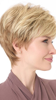 Model is wearing TIFFANY by ENVY in color SPARKLING CHAMPAGNE | Medium Brown roots with overall Strawberry Blonde base and soft Golden Blonde highlights
