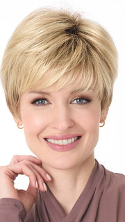 Model is wearing TIFFANY by ENVY in color SPARKLING CHAMPAGNE | Medium Brown roots with overall Strawberry Blonde base and soft Golden Blonde highlights
