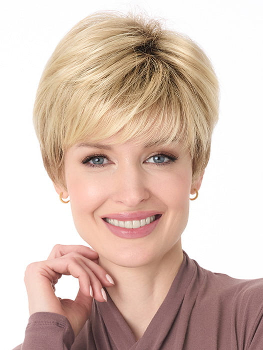 Model is wearing TIFFANY by ENVY in color SPARKLING CHAMPAGNE | Medium Brown roots with overall Strawberry Blonde base and soft Golden Blonde highlights