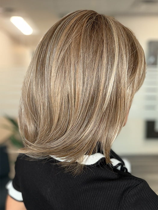 Model is wearing TIMELESS CHARM by RAQUEL WELCH in color RL12/22SS SHADED CAPPUCCINO | Light Golden Brown Evenly Blended with Cool Platinum Blonde Highlights and Dark Roots
