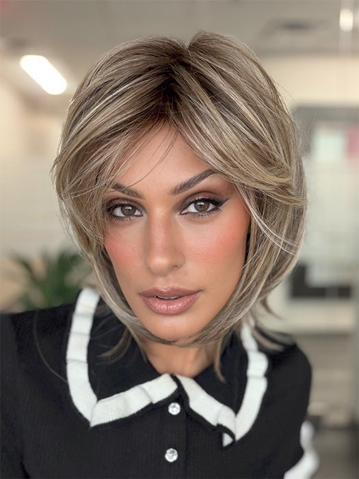 Model is wearing TIMELESS CHARM by RAQUEL WELCH in color RL12/22SS SHADED CAPPUCCINO | Light Golden Brown Evenly Blended with Cool Platinum Blonde Highlights and Dark Roots