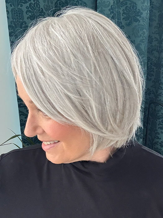 Mel B. @mels.be.ageless wearing Top Billing 8" by Raquel Welch in color RL56/60 SILVER | Lightest Gray Evenly Blended with Pure White