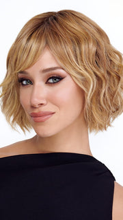 Model is wearing TREND by TRESSALLURE in color 14/26/R10 | Red Blonde with Gold Blonde Highlights and Light Brown Roots