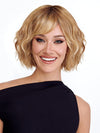 Model is wearing TREND by TRESSALLURE in color 14/26/R10 | Red Blonde with Gold Blonde Highlights and Light Brown Roots
