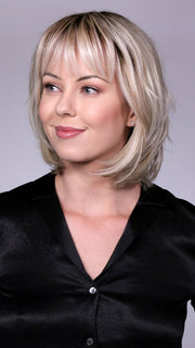 Model is wearing TRIBECA By BELLETRESS in CRUSHED-ALMOND-BLONDE-R | A Soft Neutral Light Blonde with a Light and Medium Blended Root Color