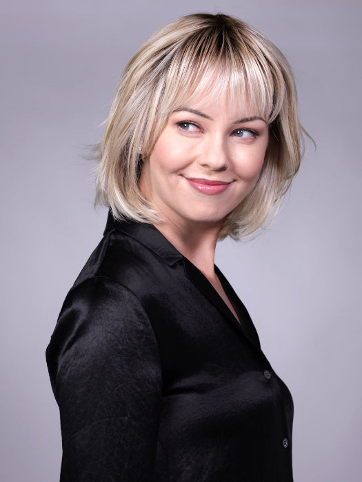 Model is wearing TRIBECA By BELLETRESS in CRUSHED-ALMOND-BLONDE-R | A Soft Neutral Light Blonde with a Light and Medium Blended Root Color