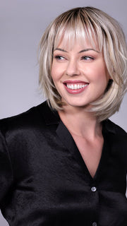 Model is wearing TRIBECA By BELLETRESS in CRUSHED-ALMOND-BLONDE-R | A Soft Neutral Light Blonde with a Light and Medium Blended Root Color