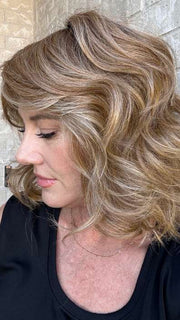 Jenny B. @thewiggygirl wearing EDITOR'S PICK ELITE by RAQUEL WELCH WIGS in color RL14/25SS | Shaded Honey Ginger | Dark Blonde Evenly Blended with Medium Golden Blonde With Dark Roots | outside natural lighting
