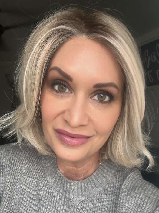 Emily H. @she_sheds_more wearing Alicante by BelleTress in shade CRUSHED ALMOND BLONDE R | A soft Neutral Light Blonde with a Light and Medium Blended Root Color.