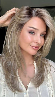 Heather @cjswigs wearing BEVERLY HILLS by BELLETRESS in color RAW SUGAR BLONDE | A Neutral Light Blonde, Honey Blonde, Pale Gold Blonde, with a base of Light Brown Low Lights featuring a Medium Root Color

