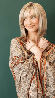 Model wearing ALVA by NORIKO in ARABIAN SAND™ | Neutral Chocolate Brown Roots fade into a Neutral Blonde Base, blended with Sandy, Chestnut, Golden, and Honey Blondes, with Soft Creamy Blonde Highlights and Face-Framing Lowlights