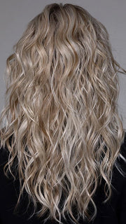 Model is wearing WESTWOOD in BUTTER BEER BLONDE | Dark Brown Base and Root that transitions smoothly into a buttery blonde, infused with creamy honey and toffee tones