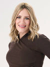 Model is wearing BARELY THERE WAVY 12" TOPPER in color PROSECCO | BROWN ROOTS WITH GOLDISH BLONDE HIGHLIGHTS