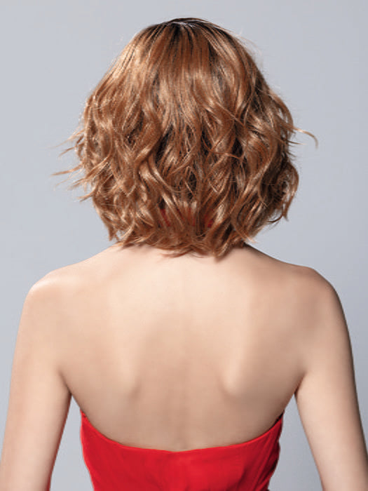 Model is wearing ELLE MONO by ELLEN WILLE in color PUMPKIN ROOTED | Dark Strawberry Blonde with Light Reddish Auburn and Copper Red Blend With Shaded Roots