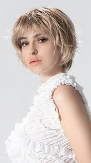 Model is wearing ESCAPE SOFT by ELLEN WILLE in color CANDY BLONDE ROOTED 101.27.60 | Pearl Platinum, Dark Strawberry Blonde and Pearl White with Shaded Roots