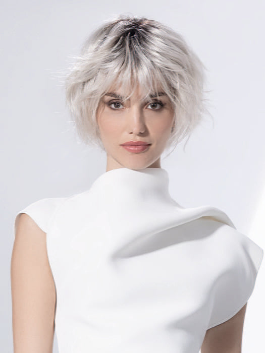 Model is wearing ESCAPE SOFT by ELLEN WILLE in color SILVER BLONDE ROOTED 60.1001.24 | Pearl White and Winter White with Lightest Ash Blonde Blend and Shaded Roots