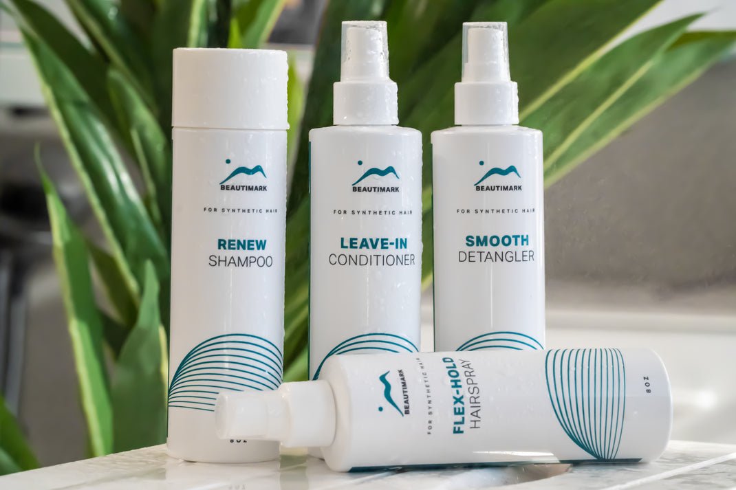 BeautiMark synthetic care products against plant. Products featured: Renew Shampoo, Leave-in Conditioner, Smooth Detangler, and Flex-Hold Hairspray.