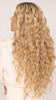 Roxie wearing CURLY GIRLIE by HAIRDO in color SS25 SHADED GINGER BLONDE | Golden Blonde with Subtle Highlights and Medium Brown Roots
