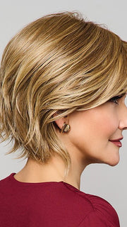 Model is wearing MAIN CHARACTER by RAQUEL WELCH in RL 13/88 GOLDEN PECAN | Neutral Medium Blonde With Pale Honey Blonde Highlight