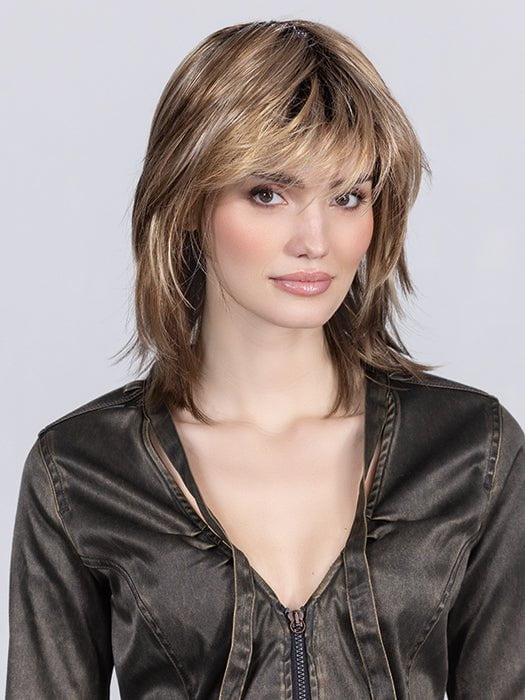 Model is wearing SAND MULTI ROOTED SAND MULTI ROOTED 14.24.12 | Medium Ash Blonde, Lightest Ash Blonde, and Lightest Brown Blend with Dark Shaded Roots