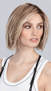Model is wearing SAND MULTI ROOTED | Lightest Brown and Light Neutral Blonde with Light Reddish Auburn Blend and Shaded Roots