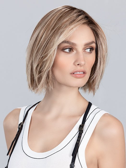 Model is wearing SAND MULTI ROOTED | Lightest Brown and Light Neutral Blonde with Light Reddish Auburn Blend and Shaded Roots