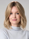 Model is wearing CHARLOTTE HAND TIED by ENVY in color PROSECCO (12/24/102R8)| Rooted Neutral Light Medium Blonde