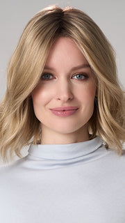 Model is wearing CHARLOTTE HAND TIED by ENVY in color PROSECCO (12/24/102R8)| Rooted Neutral Light Medium Blonde