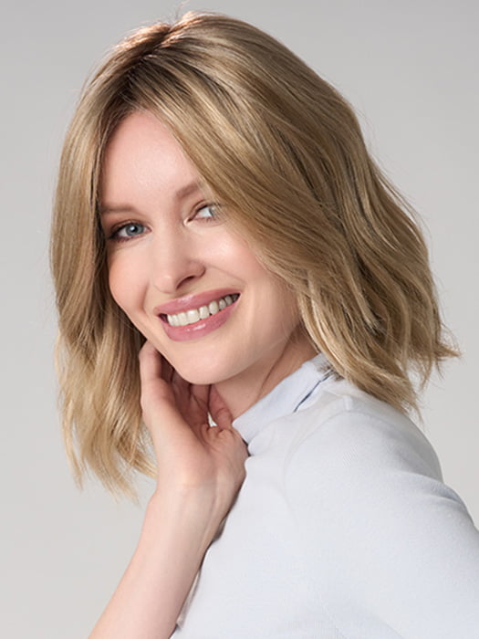 Model is wearing CHARLOTTE HAND TIED by ENVY in color PROSECCO (12/24/102R8)| Rooted Neutral Light Medium Blonde