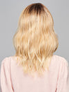 Model is wearing ASPIRATION by GABOR in color SS-LIGHT-BLONDE | Light Blonde with Golden Highlights & Dark Brown Roots
