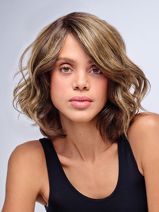 Model is wearing 10" AU NATUREL WAVES TOPPER in color SS9/24 ICED CAFÉ LATTE | Dark Brown shaded with Golden Brown