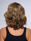 Model is wearing 10" AU NATUREL WAVES TOPPER in color SS9/24 ICED CAFÉ LATTE | Dark Brown shaded with Golden Brown