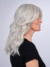 Model is wearing 16" AU NATUREL WAVES TOPPER by HAIRDO in color R56/60 SILVER MIST | Lightest Gray with 20% Medium Brown Evenly Blended with Pure White