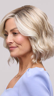 Model is wearing JANUARY PETITE by JON RENAU in color 101/88/27S8 CATALINA BLONDE | Pale blonde with Pure White Natural Violet halo highlights, shaded medium brown